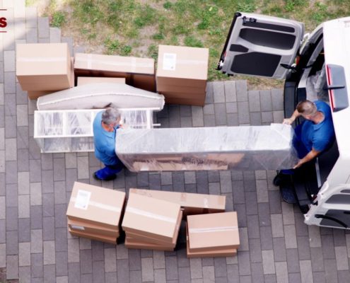 movers transporting boxes into a truck - Kyle's Kollectibles liquidation