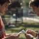 two young men swapping baseball cards - Kyle's Kollectibles selling baseball cards