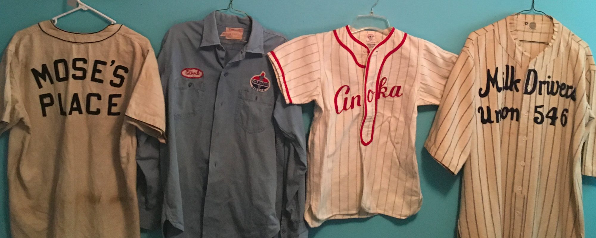 four vintage Minnesota jerseys hung up on a blue wall - Kyle's Kollectibles