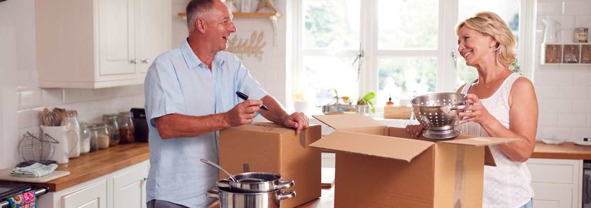 older man and woman packing up their kitchen - Kyle's Kollectibles house clearing & liquidation